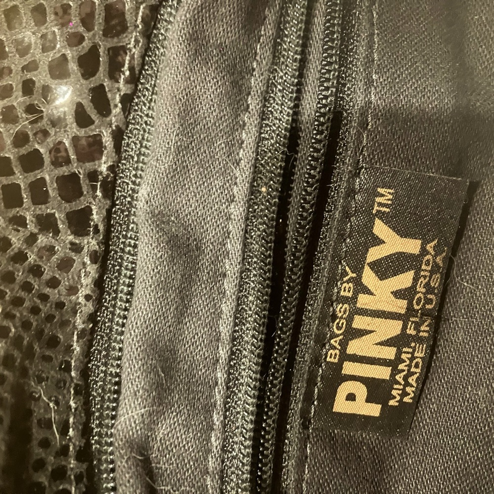 Super cute party/evening clutch with inside pocket. Made in USA. Faux skin.
